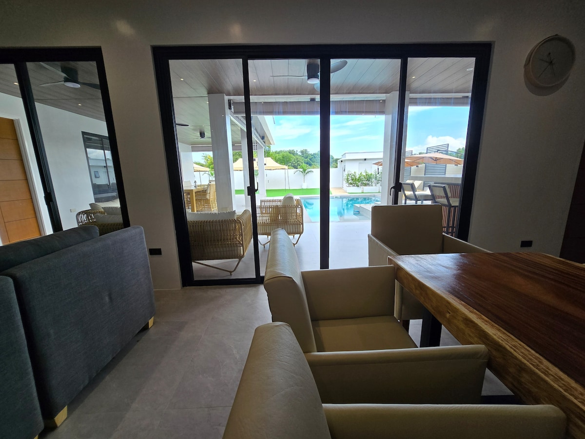 Living room view through glass sliding doors to pool terrace